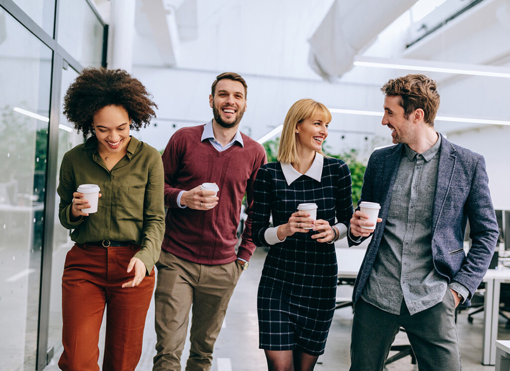 Blog - Group of Friendly Business Professionals Walking Together in an Office