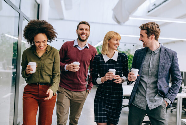 Blog - Group of Friendly Business Professionals Walking Together in an Office