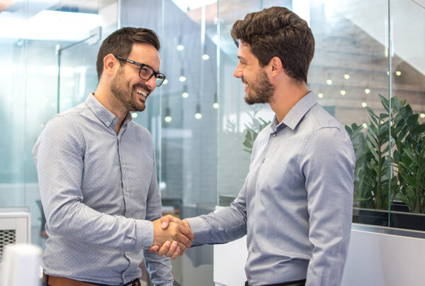 Why Cross-Selling is Key - Two Business People Shaking Hands