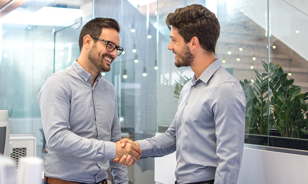 Why Cross-Selling is Key - Two Business People Shaking Hands